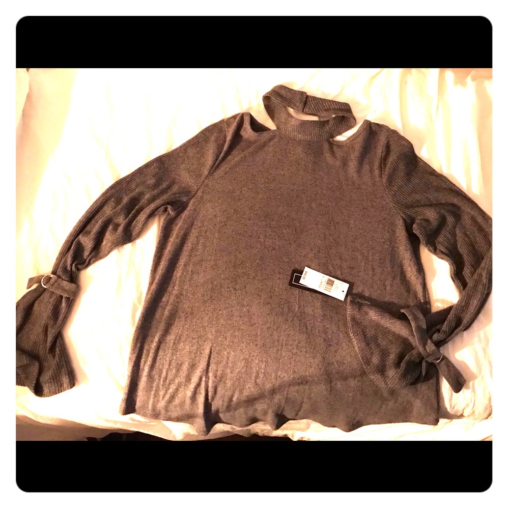 A. Burr choker neck sweater with buckle accent